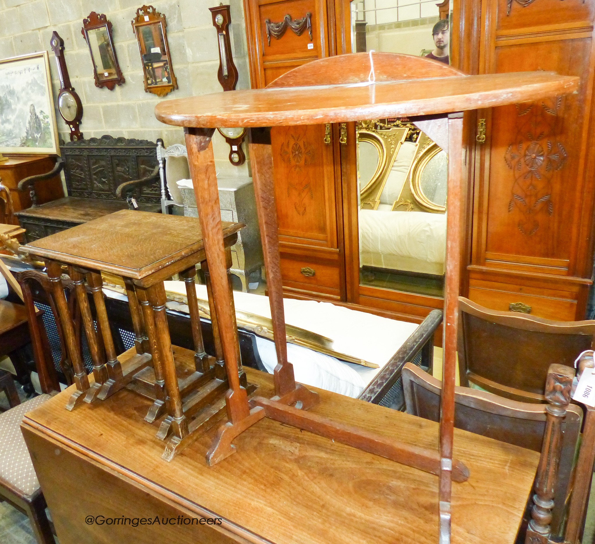 An Arts & Crafts style oak side table, 89cm high, 76 x 37cm together with a nest of three oak occasional tables, 48cm high, 36 x 45cm (2)